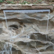 Искусственный каскадный водопад с двумя изливами, изготовлен и установлен в городе Сочи для ландшафтного дизайна территории размером 6,5 на 5 метров из полимер бетона.